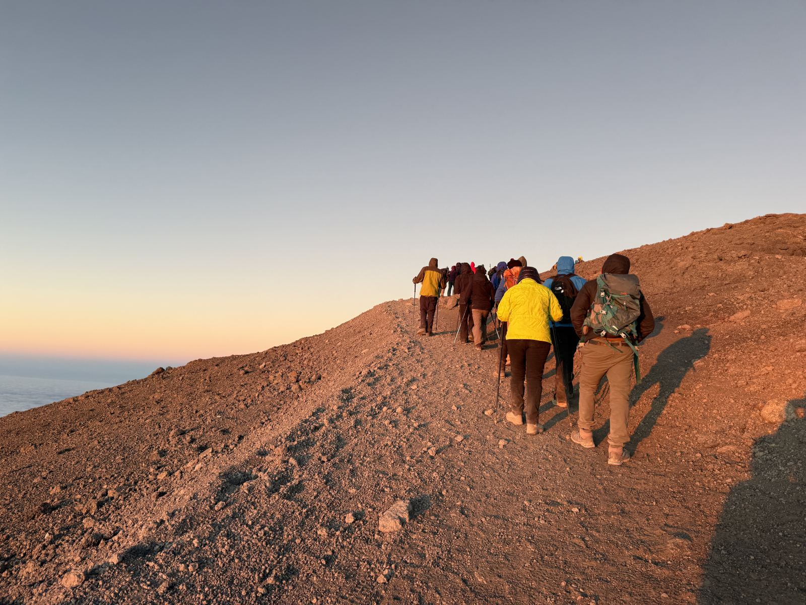 Kilimanjaro climbers on the summit ridge at sunrise